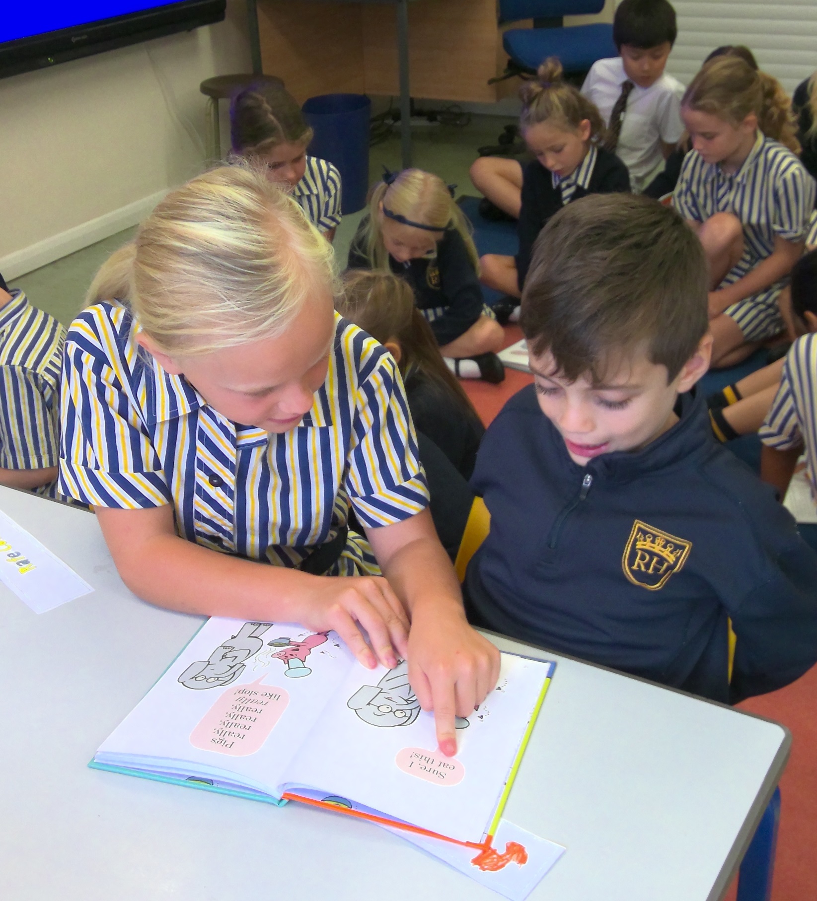 Year 5 spent some time reading with the year 2 pupils Year 5 child reading to a Year 2 child